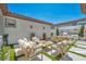 Inviting backyard patio featuring lounge seating, outdoor dining, and a built-in barbecue, perfect for entertaining at 10528 Garden Light Dr, Las Vegas, NV 89135