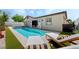 Private backyard oasis with a refreshing pool and comfortable lounge chairs, perfect for relaxation at 10528 Garden Light Dr, Las Vegas, NV 89135
