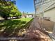 This shady backyard features a lush lawn, mature trees, and a covered patio for outdoor relaxation at 10561 Rancho Destino Rd, Las Vegas, NV 89183