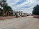 Spacious ranch home showcasing a grand front entrance and driveway with lush landscaping and a secure gate at 10561 Rancho Destino Rd, Las Vegas, NV 89183