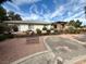 Charming ranch-style home featuring a well-maintained yard, mature landscaping, and a cozy front bench at 10561 Rancho Destino Rd, Las Vegas, NV 89183