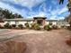 Inviting single-story home with landscaped front yard, mature trees, and a covered entryway at 10561 Rancho Destino Rd, Las Vegas, NV 89183