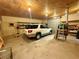 Spacious garage featuring a vehicle and convenient roll-up door at 10561 Rancho Destino Rd, Las Vegas, NV 89183