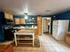 Cozy kitchen with wooden cabinetry, tile flooring, modern appliances, and an eat-in island at 10561 Rancho Destino Rd, Las Vegas, NV 89183