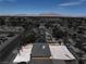 Expansive aerial view of a single story home and a large backyard filled with neutral toned gravel at 1109 E Tonopah Ave, North Las Vegas, NV 89030