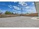 Large backyard, featuring a privacy fence and desert landscaping with clear sky at 1109 E Tonopah Ave, North Las Vegas, NV 89030