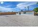 The backyard boasts a spacious yard with gravel and privacy fence at 1109 E Tonopah Ave, North Las Vegas, NV 89030