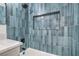 Modern bathroom features blue tiled walls, built-in shower niche, and bathtub at 1109 E Tonopah Ave, North Las Vegas, NV 89030