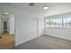 Well-lit bedroom featuring closet, adjacent bathroom and light colored carpeting at 1109 E Tonopah Ave, North Las Vegas, NV 89030