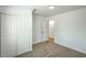 Spacious bedroom offers closet space, and an adjacent door with neutral carpeting at 1109 E Tonopah Ave, North Las Vegas, NV 89030