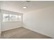 Bright bedroom with large window allowing natural light, and neutral carpeting at 1109 E Tonopah Ave, North Las Vegas, NV 89030