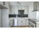 Modern kitchen featuring stainless steel appliances, sleek cabinets, and black tile backsplash at 1109 E Tonopah Ave, North Las Vegas, NV 89030