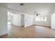 Spacious living room with bright white walls, modern ceiling fan, and sleek light-colored flooring at 1109 E Tonopah Ave, North Las Vegas, NV 89030