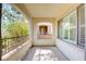 Outdoor balcony with concrete floor and wrought iron railing with view of foliage and trees at 11833 Amistoso Ln, Las Vegas, NV 89138