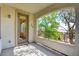 Outdoor balcony with concrete floor and wrought iron railing with view of foliage and trees at 11833 Amistoso Ln, Las Vegas, NV 89138