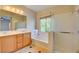 Bathroom featuring double sinks, soaking tub, and glass-enclosed shower with natural light from windows at 11833 Amistoso Ln, Las Vegas, NV 89138
