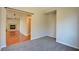 Bright bedroom with neutral carpeting adjacent to living area with fireplace at 11833 Amistoso Ln, Las Vegas, NV 89138