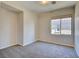 Well-lit bedroom featuring neutral carpeting and a window bringing in natural light at 11833 Amistoso Ln, Las Vegas, NV 89138