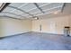 Spacious garage featuring a concrete floor and a white door at 11833 Amistoso Ln, Las Vegas, NV 89138