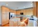Bright kitchen features stainless steel appliances, an island with granite countertops, and light wood cabinetry at 11833 Amistoso Ln, Las Vegas, NV 89138