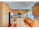 Bright kitchen features stainless steel appliances, an island with granite countertops, and light wood cabinetry at 11833 Amistoso Ln, Las Vegas, NV 89138