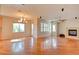 Spacious living room featuring hardwood floors, a cozy fireplace, and ample natural light at 11833 Amistoso Ln, Las Vegas, NV 89138