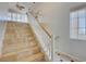 Bright staircase features tile steps, white risers, and wood handrail, bathed in natural light at 11833 Amistoso Ln, Las Vegas, NV 89138