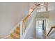 Bright staircase features tile steps, white risers, and wood handrail, bathed in natural light at 11833 Amistoso Ln, Las Vegas, NV 89138