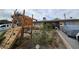 A single-story home with a playground structure in front and a wrought iron fence at 1338 Smoke Tree Ave, Las Vegas, NV 89108