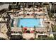 Aerial view of a modern pool deck with cabanas, lush landscaping, and comfortable lounge chairs at 135 E Harmon Ave # 3620, Las Vegas, NV 89109