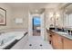 Bright bathroom with a soaking tub, view, and modern vanity at 135 E Harmon Ave # 3620, Las Vegas, NV 89109