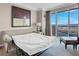 Relaxing bedroom with a pullout sofa bed, balcony access, and city views at 135 E Harmon Ave # 3620, Las Vegas, NV 89109