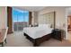 Bright bedroom with a plush bed, scenic views from expansive windows, and a nightstand at 135 E Harmon Ave # 3620, Las Vegas, NV 89109