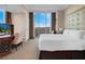 Bright bedroom with a plush bed, scenic views from expansive windows, and a workspace at 135 E Harmon Ave # 3620, Las Vegas, NV 89109