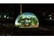 A digital dome is displaying a garden inside, surrounded by the night skyline of Las Vegas at 135 E Harmon Ave # 3620, Las Vegas, NV 89109
