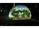 The Sphere is lit up at night with a tropical landscape projection at 135 E Harmon Ave # 3620, Las Vegas, NV 89109