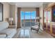 Relaxing living space with a couch, chair and ottoman, a writing desk, and expansive skyline views at 135 E Harmon Ave # 3620, Las Vegas, NV 89109