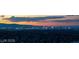 Beautiful city skyline view with orange skies at sunset and city lights beginning to illuminate at 1491 Reims Dr, Henderson, NV 89012