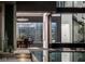 A modern dining space reflected in the swimming pool's surface, complemented by open access to the kitchen and outdoor areas at 1491 Reims Dr, Henderson, NV 89012