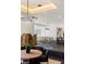 An elegant dining area featuring modern decor and a partial view of the open kitchen at 1491 Reims Dr, Henderson, NV 89012
