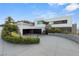 Modern home showcasing clean lines, multi-car garage, xeriscaped landscaping and a circular driveway at 1491 Reims Dr, Henderson, NV 89012