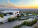 Modern home exterior with a curved driveway and lush landscaping nestled within city views at 1491 Reims Dr, Henderson, NV 89012