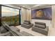 Comfortable media room featuring plush seating, a large screen, and city views for entertainment at 1491 Reims Dr, Henderson, NV 89012