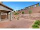 View of backyard featuring patio, privacy wall, rock landscaping, and drought resistant shrubs at 15 Santo Mio Ct, Henderson, NV 89011
