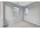 Bedroom featuring two windows for natural light, neutral walls, and carpet at 15 Santo Mio Ct, Henderson, NV 89011