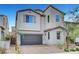 Charming two-story home with tan paint, a tile roof, desert landscaping, and a convenient two-car garage at 15 Santo Mio Ct, Henderson, NV 89011