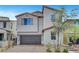 Two-story home featuring neutral paint, desert landscaping, a tile roof, and an attached two-car garage at 15 Santo Mio Ct, Henderson, NV 89011