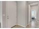 Clean, neutral foyer with tile flooring, a white door, and a view into a naturally lit bedroom at 15 Santo Mio Ct, Henderson, NV 89011