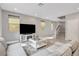 Spacious living room featuring a comfortable sofa, entertainment center, and access to the stairway at 15 Santo Mio Ct, Henderson, NV 89011