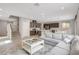 Open-concept layout with gray sectional sofa, kitchen and a staircase at 15 Santo Mio Ct, Henderson, NV 89011